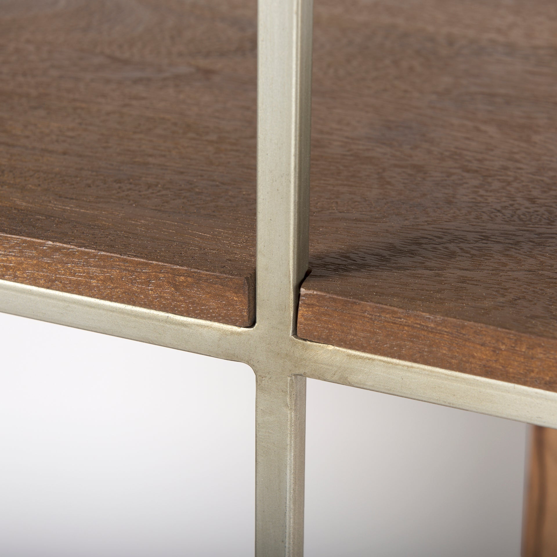 Close-up detail of the welded silver metal frame cross-sections on the Maddox geometric bookcase.