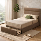 Maelle Upholstered Storage Bed styled with neutral bedding and green accent pillows in a bedroom, with the footboard storage drawer open.