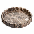 Marais round brown marble-look cement tray with a scalloped rim on a white background.
