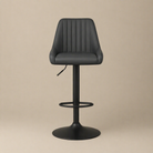 Black bar stool with quilted seat on a beige background