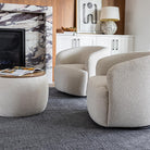 Two Milo swivel chairs styled with a matching round bouclé ottoman in a contemporary home setting.