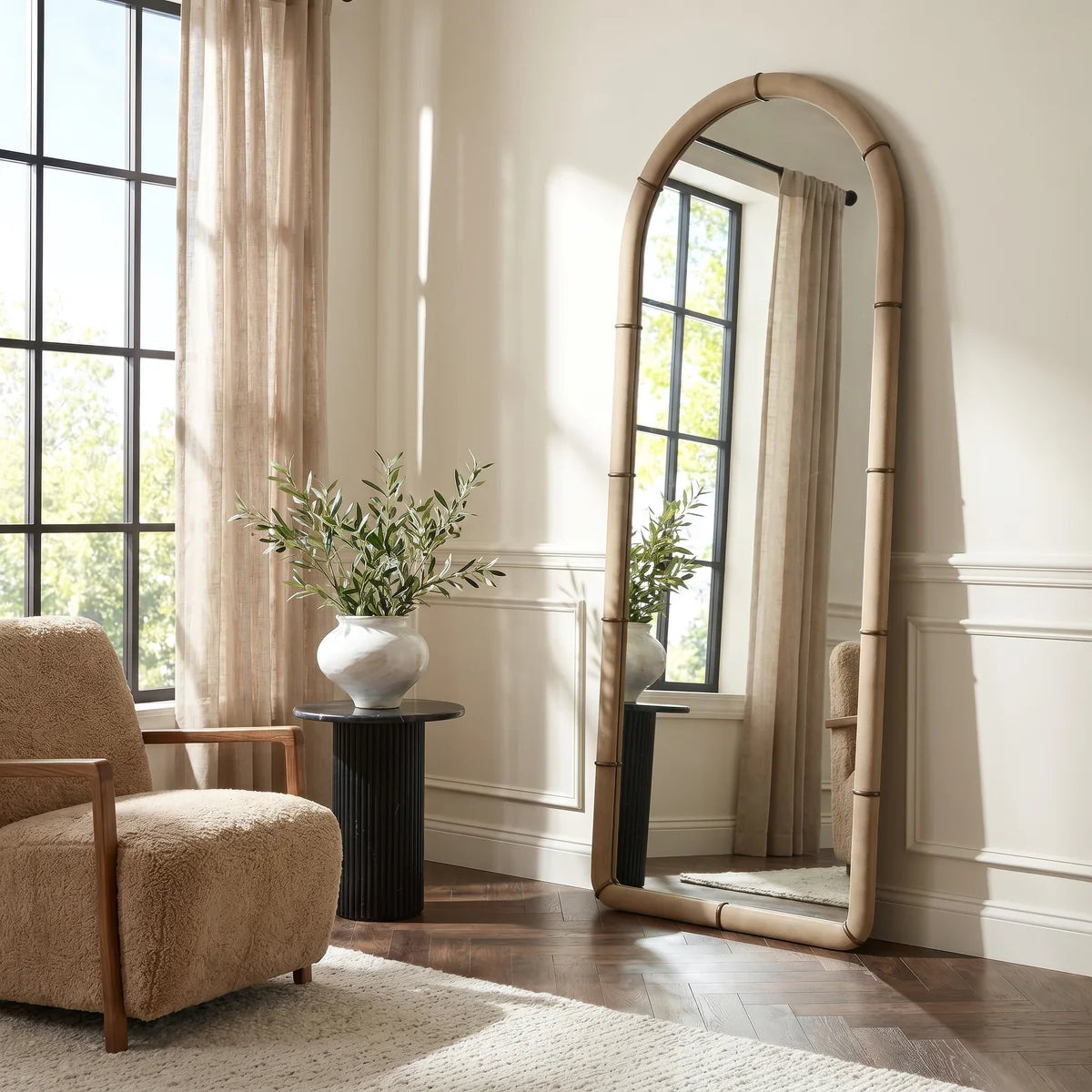 Mirelle Full-Length Mirror styled as a leaning floor mirror in a warm neutral living space with soft natural light.
