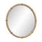 Angled view of the Mirelle Round Wall Mirror showing its circular form and beige vegan leather frame with antique metal band accents.