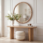 Mirelle Round Wall Mirror styled above a wood console in a bright neutral interior.
