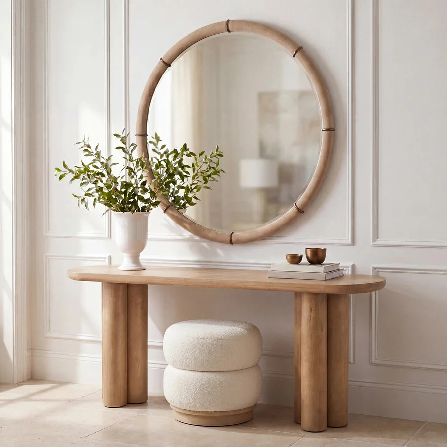 Mirelle Round Wall Mirror styled above a wood console in a bright neutral interior.