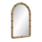 Angled view of the Mirelle Wall Mirror showing its arched form and beige vegan leather frame with antique metal band accents.