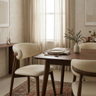 Close-up of the Modern Leather Ash Wood Dining Chair styled at a wooden table with a minimalist vase and linen napkin.