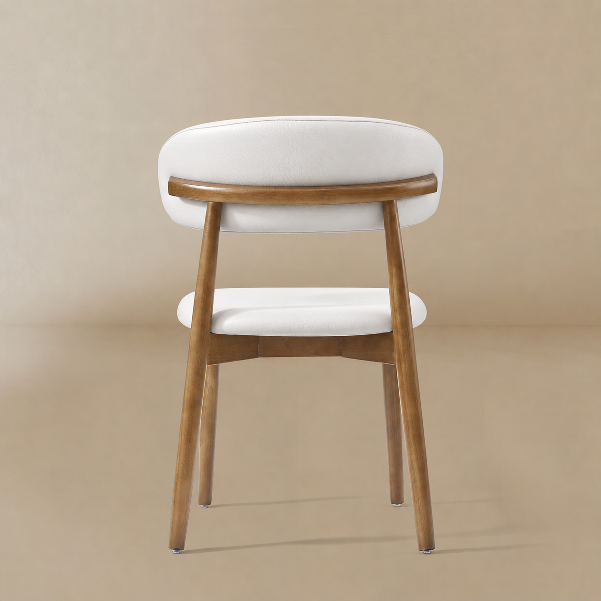 Back view of a cream PU leather dining chair with a curved walnut-finished ash wood frame featuring the Modern PU Leather Ash Wood Dining Side Chair