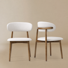 Pair of cream PU leather dining chairs with walnut-finished ash wood frames, shown from the front and back featuring the Modern PU Leather Ash Wood Dining...