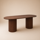 Angled view of a wooden dining table on a beige background.