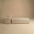 Travertine pattern coffee table, square side table,  tall side table on a beige background