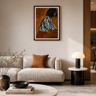 Modern living room with a framed artwork on the wall, a sofa, and a side table.