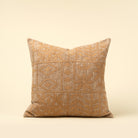 Textured pillow with geometric pattern on a beige background