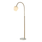Noemi floor lamp illuminated to show the warm glow through its opal glass shade.