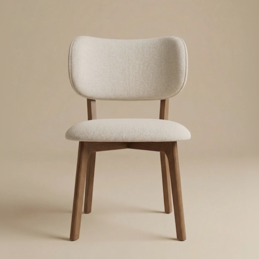 Front view of the Nolan dining chair featuring a curved backrest and seat upholstered in cream herringbone linen with a dark ash wood frame