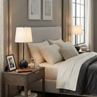 A set of black Nox marble orb lamps styled on walnut nightstands in a modern bedroom with grey upholstered bedding.