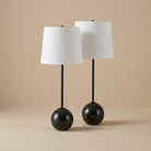 A pair of Nox table lamps featuring spherical black marble bases and matching minimalist black stems.