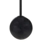 Macro close-up of the Nox lamp highlighting the polished black marble base and matching matte black metal stem.