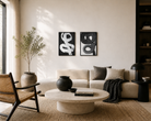 Modern living room with a beige sofa, round coffee table, and decorative wall art.