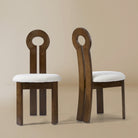 Front and angle view of the Obsidian Loop Dining Chair in a light beige studio background
