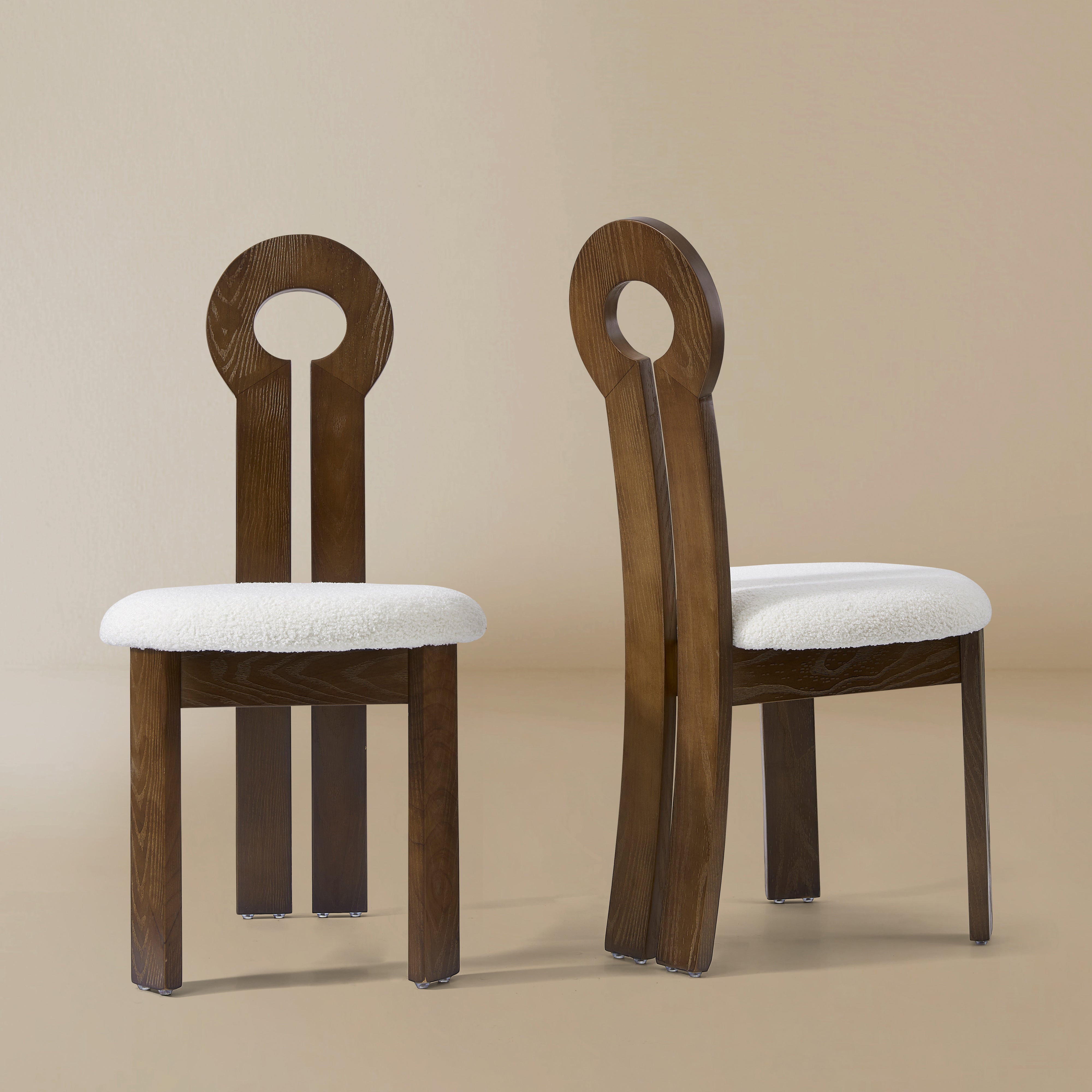 Front and angle view of the Obsidian Loop Dining Chair in a light beige studio background