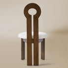 Back view of the Obsidian Loop Dining Chair in a light beige studio background