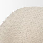 Close-up of the Octavia dining armchair’s curved upholstered back