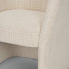 Close-up of the Octavia dining armchair’s cushioned seat and integrated arm