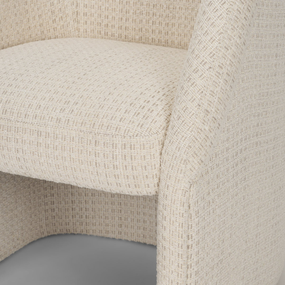 Close-up of the Octavia dining armchair’s cushioned seat and integrated arm