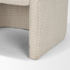 Detail of the Octavia dining armchair’s fully upholstered sculptural base