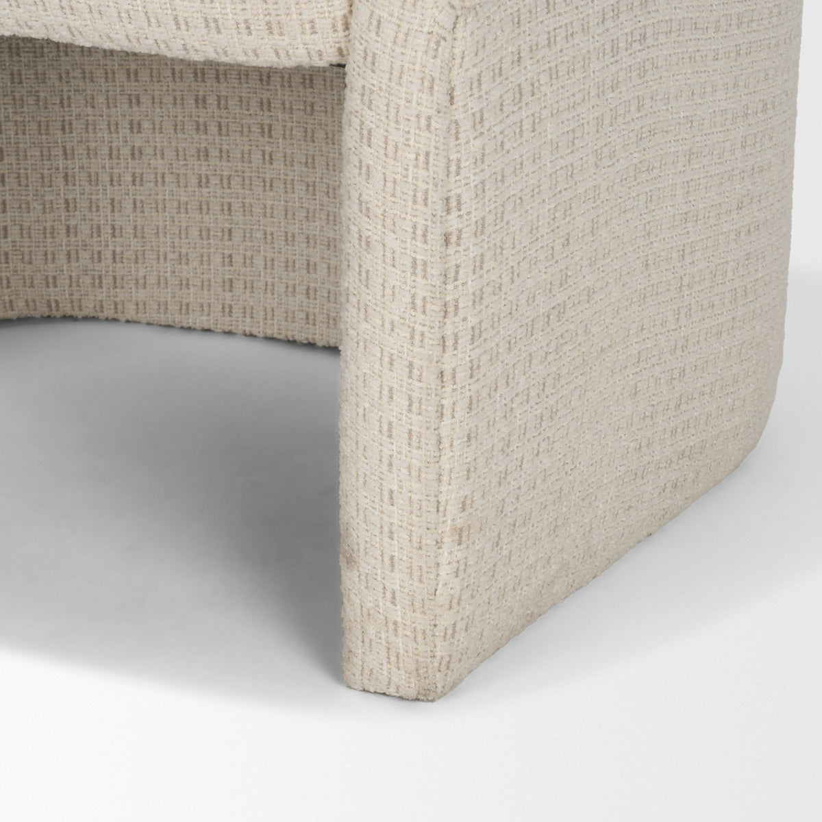 Detail of the Octavia dining armchair’s fully upholstered sculptural base