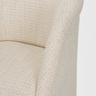 Detail of the textured cream upholstery on the Octavia dining armchair