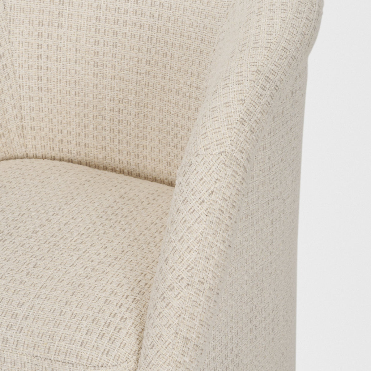 Detail of the textured cream upholstery on the Octavia dining armchair