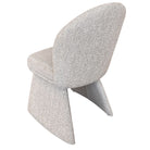 Rear angled studio view of the Odette chair showing the seamless upholstery and sculptural tapering legs