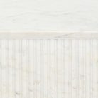 Fluted marble table base detail with veining pattern