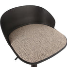 Close-up detail of the black Orla stool highlighting the textured woven seat cushion contrasting with the dark shell.