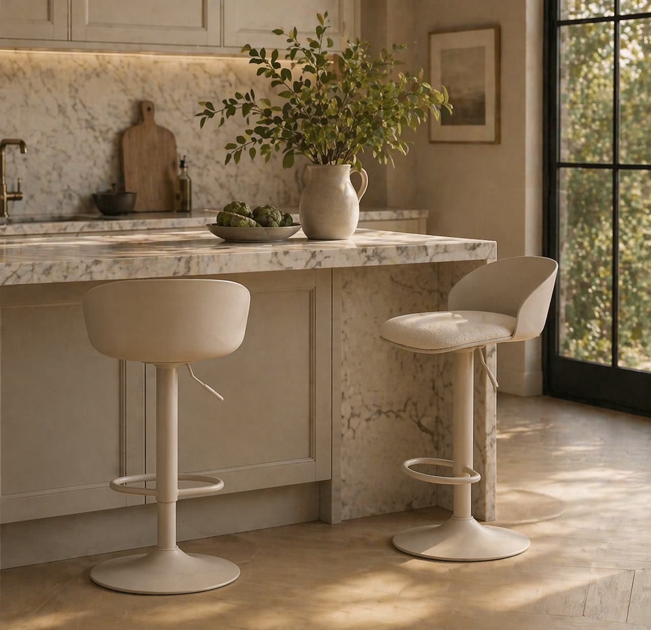 Modern kitchen with marble island and bar stools, featuring a vase with greenery.