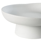 Close-up of Orla Ceramic Bowl showing matte white texture and curved pedestal base