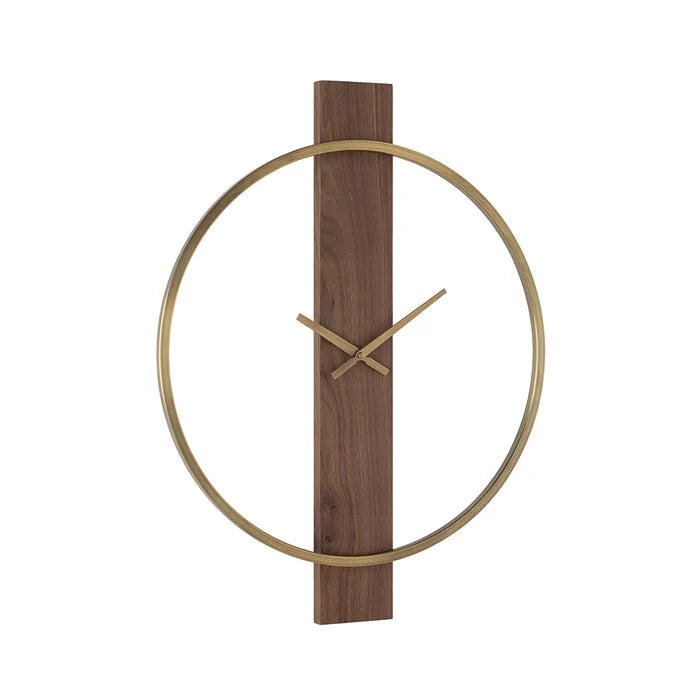 Orvella wall clock viewed at an angle, showing the open antique brushed brass ring and vertical walnut wood panel.