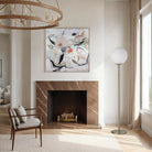 Pearl Glow Floor Lamp with white globe shade and brass stand beside a fireplace in a modern living room.