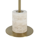 Close-up of the Perrin floor lamp's natural beige travertine base and antique brass foot.