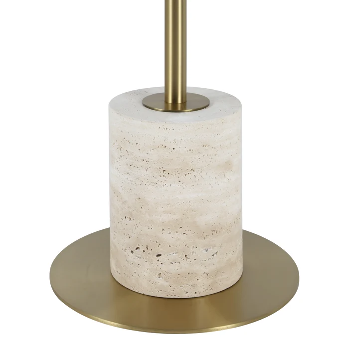 Close-up of the Perrin floor lamp's natural beige travertine base and antique brass foot.