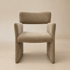 [Plena Dining Chair] Front view showing the taupe chenille upholstery, curved backrest, padded seat, and full-height panel arms.