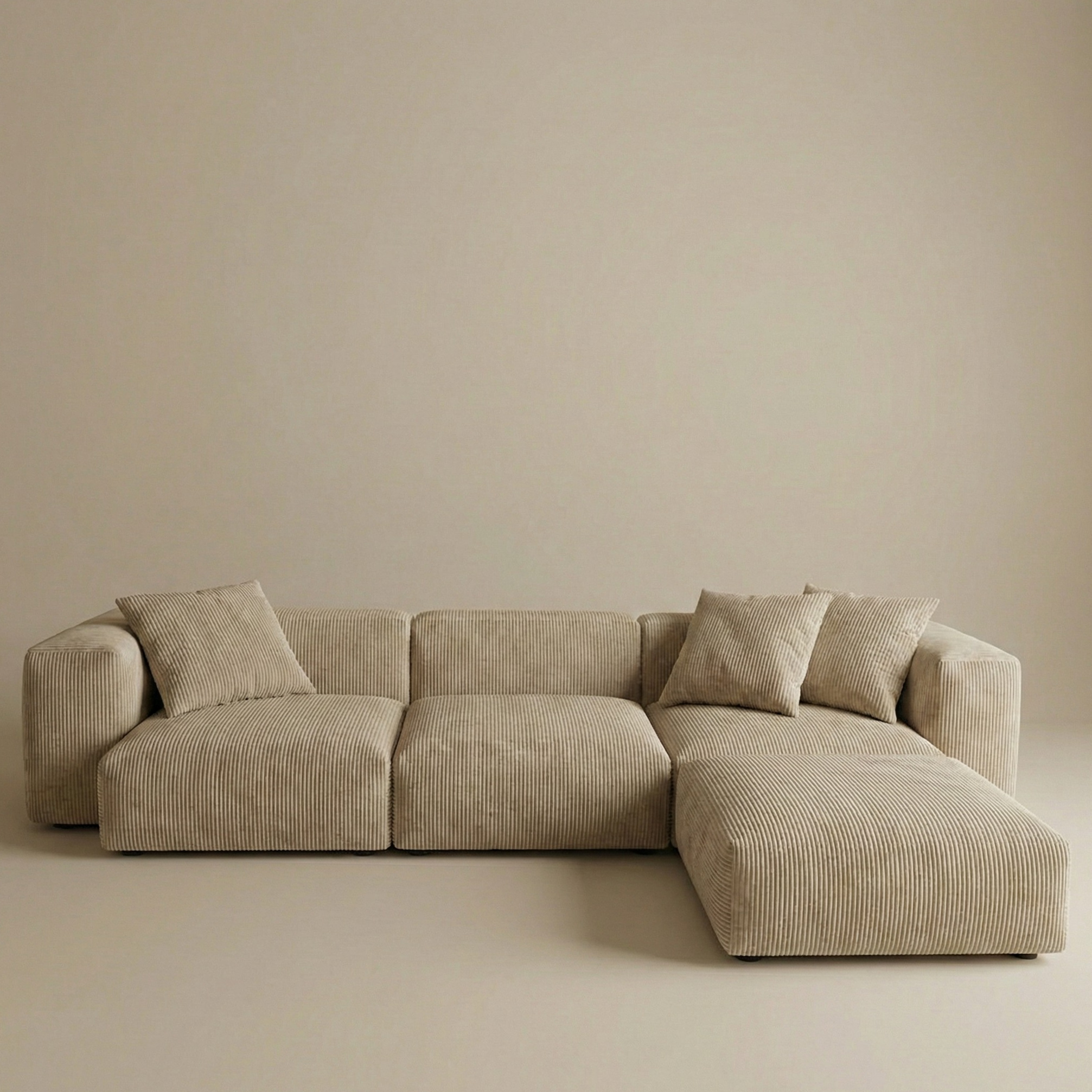 Beige plush corduroy modular sofa with luxury goose down filling against a neutral wall.