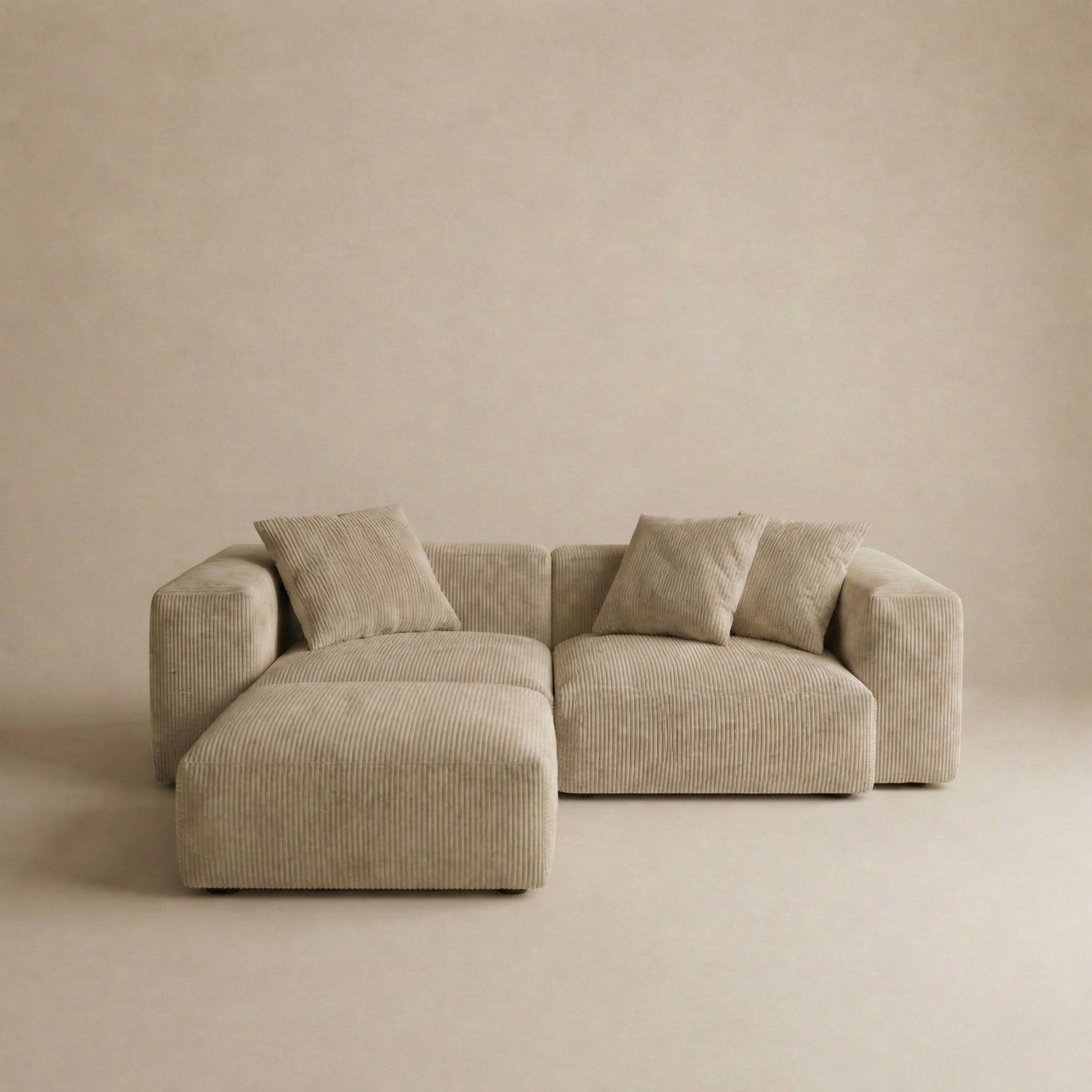 Beige sectional sofa against a plain beige wall