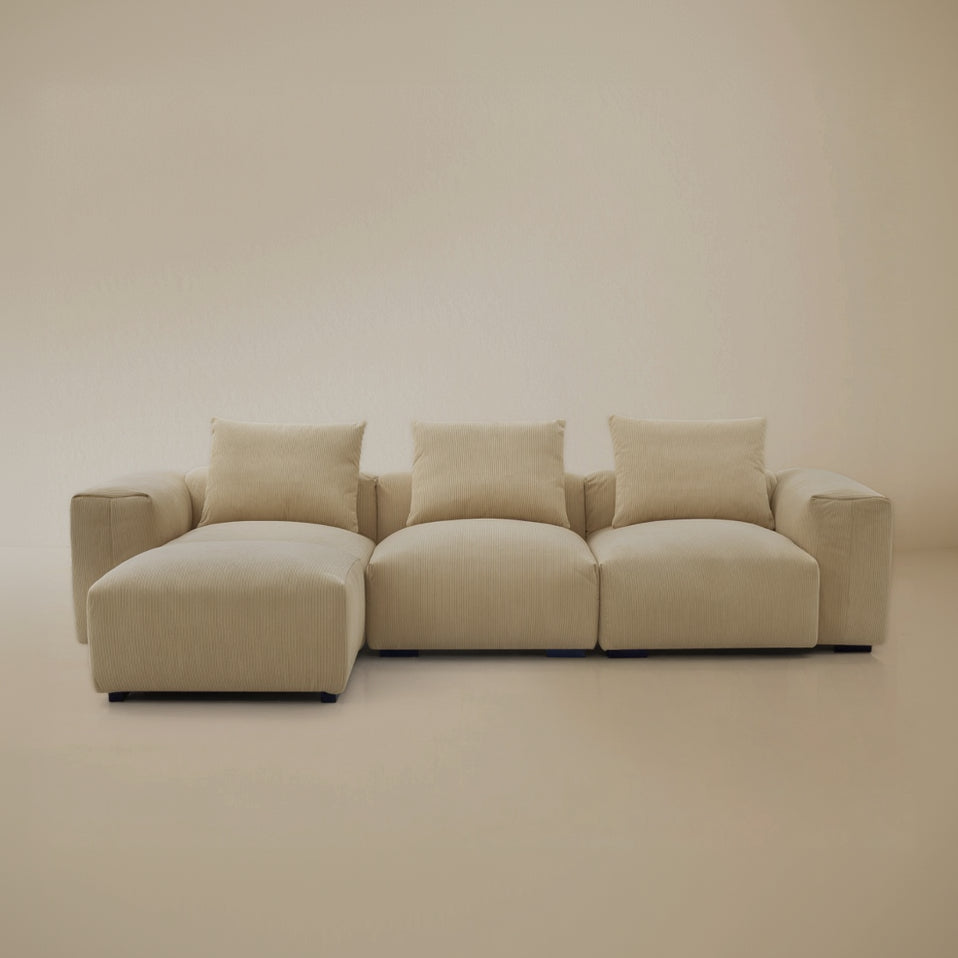 Sectional with ottoman Beige plush corduroy modular sofa in a studio background