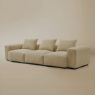 Angle view of the beige plush corduroy modular sofa in a studio background