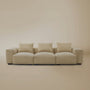 Beige plush corduroy modular sofa in sectional configuration in a studio background