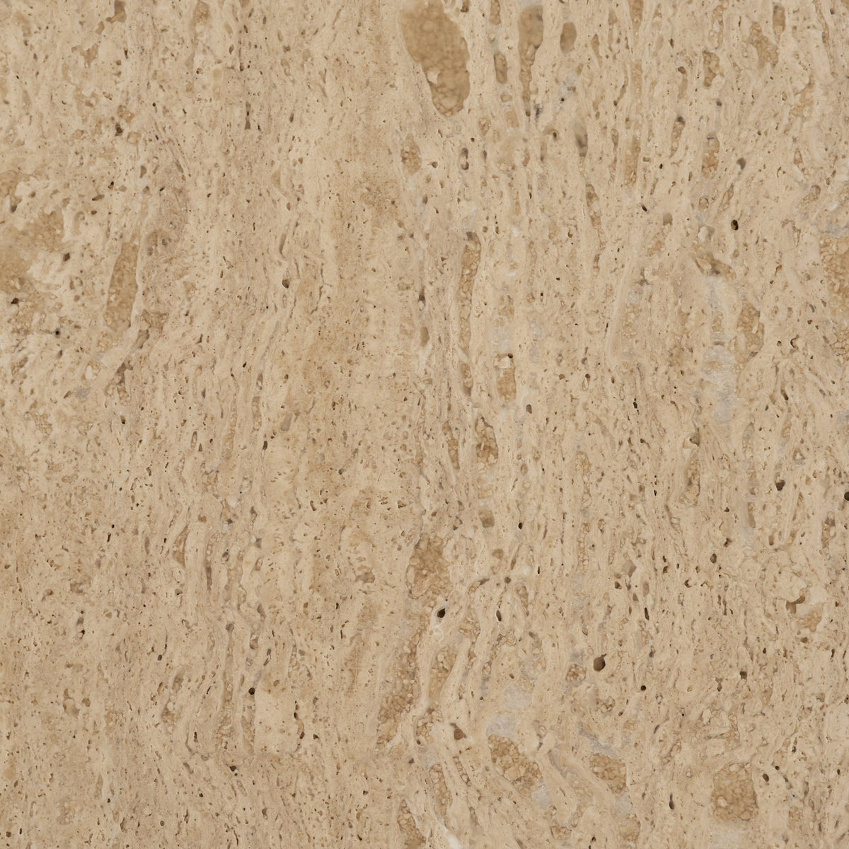 Close-up material swatch showing the natural pores and warm beige tones of Romina travertine