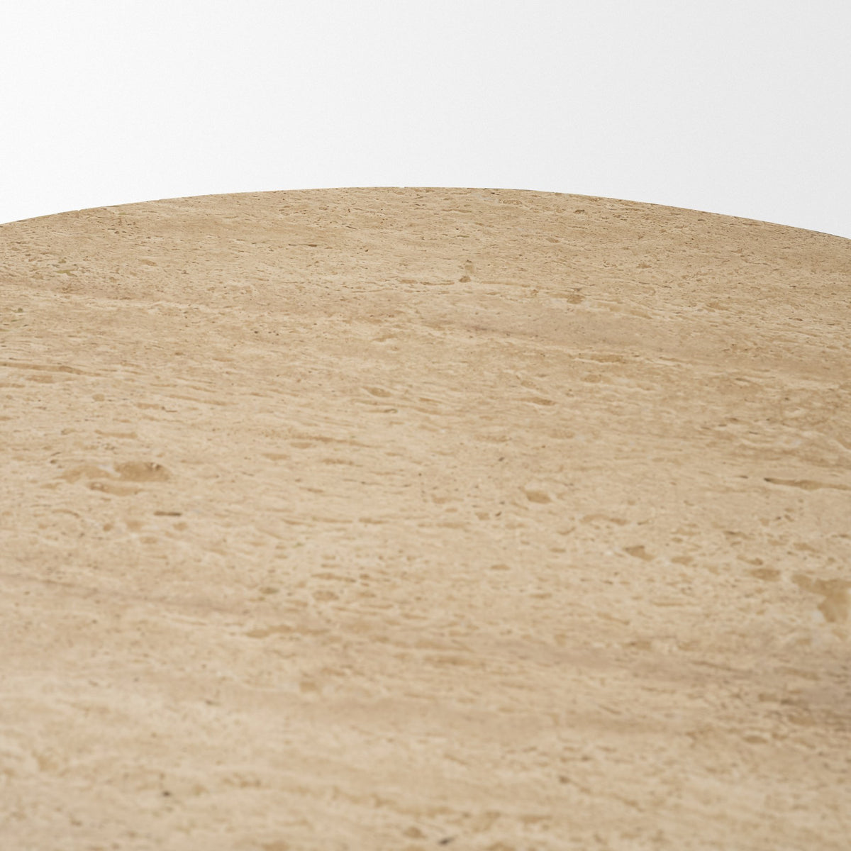 Close-up of the natural pores, markings, and tonal variation in the Romina travertine tabletop